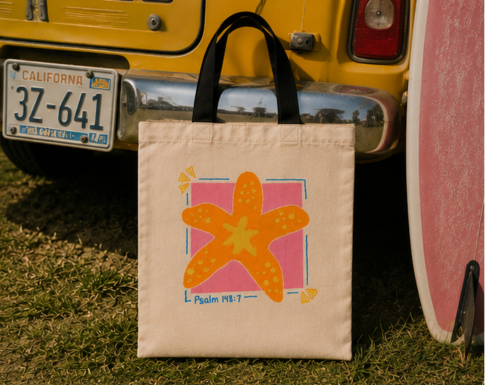 Psalm 148:7 starfish tote bag photographed beside a yellow vintage vehicle and surfboard in bright coastal sunlight.